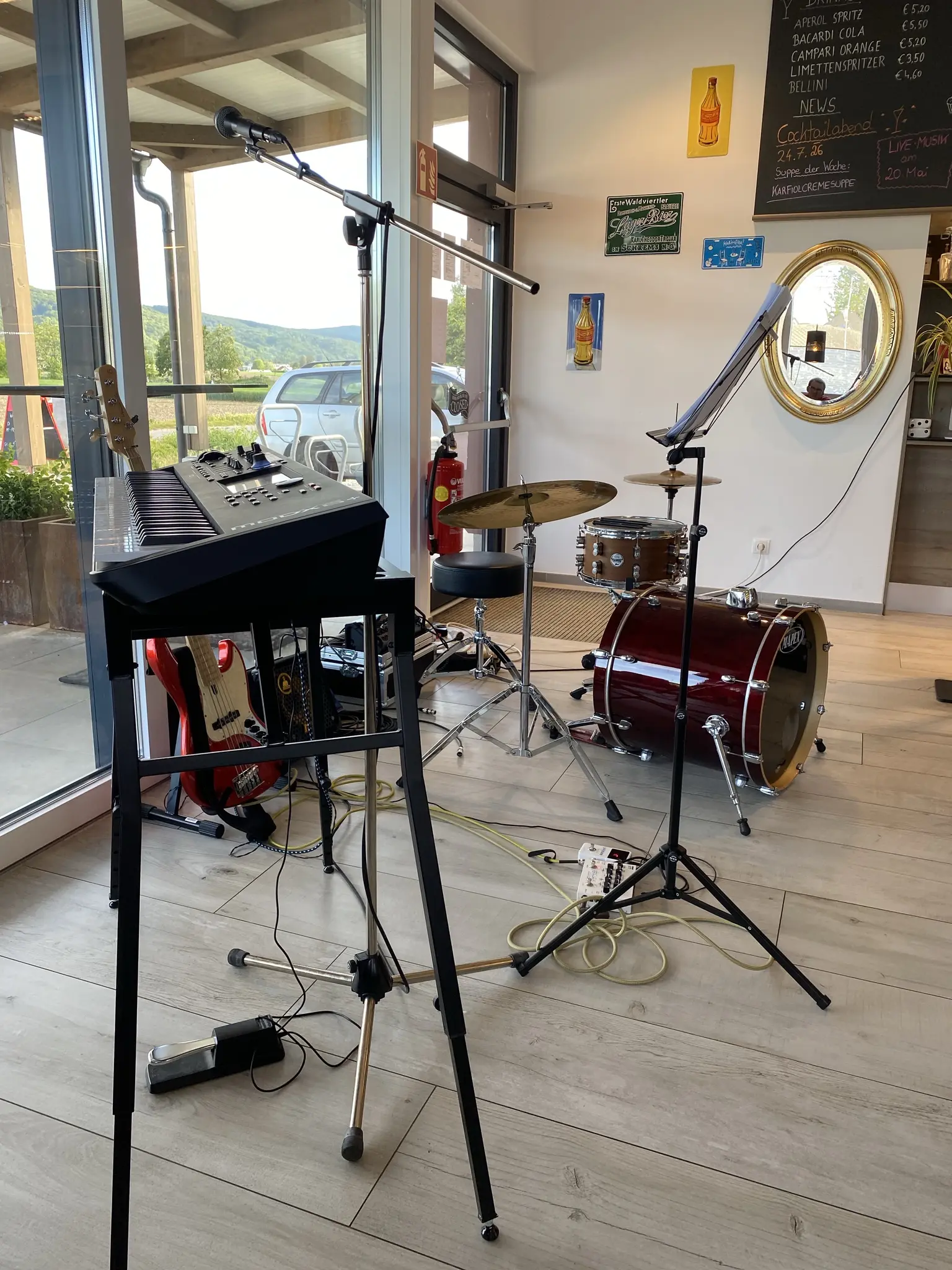 A piano, a drum-set and a bass setup in a restaurant